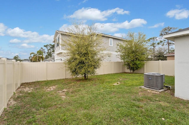 view of yard featuring a fenced backyard and central AC