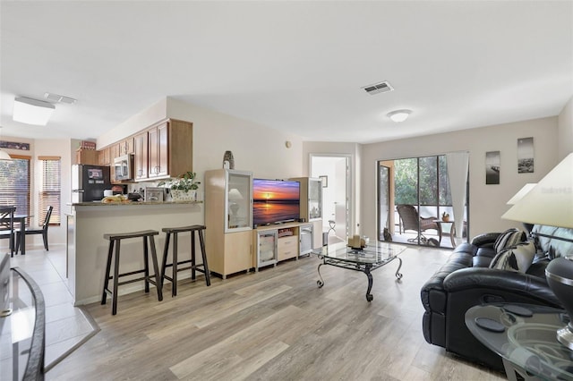 living area with visible vents and light wood-type flooring