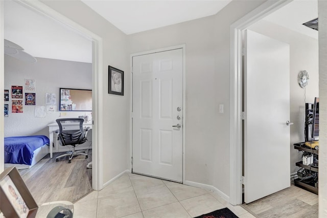 entrance foyer with light wood-type flooring and baseboards