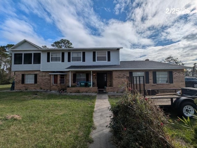 traditional-style home featuring covered porch, a front lawn, brick siding, and stucco siding