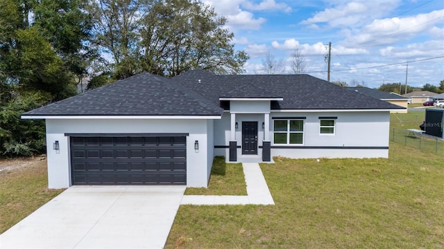 view of front of property with a garage, a shingled roof, concrete driveway, a front lawn, and stucco siding