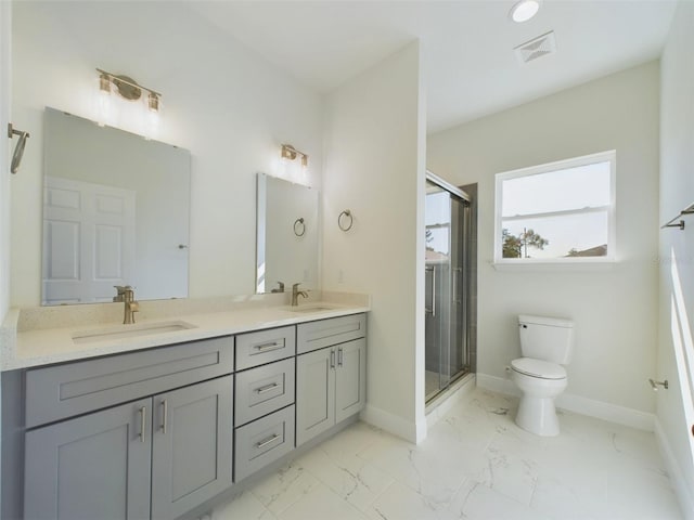 bathroom with toilet, marble finish floor, a sink, and visible vents