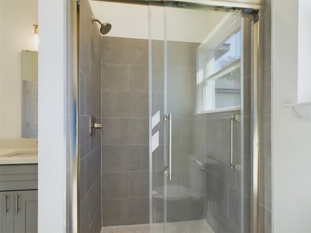 bathroom with a stall shower and vanity