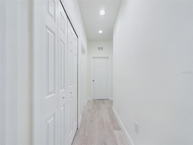 corridor with recessed lighting, light wood-type flooring, visible vents, and baseboards