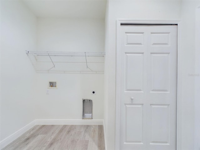 clothes washing area featuring laundry area, baseboards, light wood-style floors, washer hookup, and electric dryer hookup