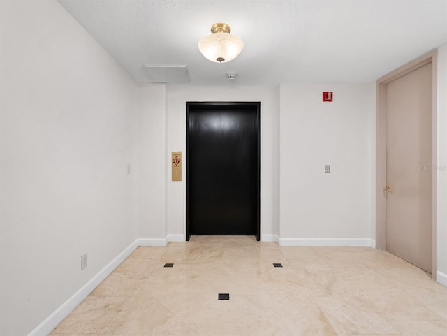 interior space with elevator and baseboards