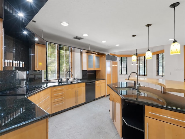 kitchen featuring light brown cabinets, black appliances, dark stone countertops, and a sink