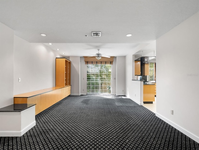 unfurnished living room with recessed lighting, carpet flooring, visible vents, and baseboards