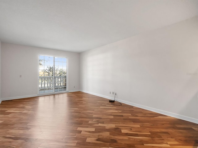 unfurnished room featuring wood finished floors and baseboards