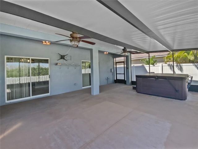 view of patio / terrace with a ceiling fan, fence, and a hot tub