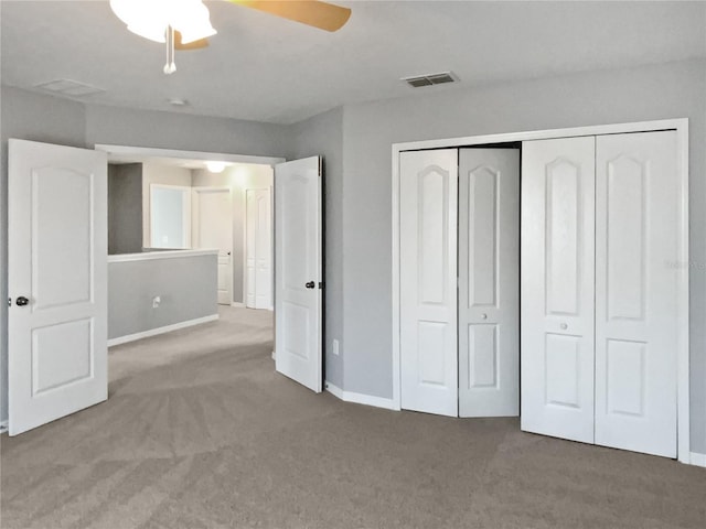 unfurnished bedroom with ceiling fan, carpet floors, visible vents, baseboards, and a closet