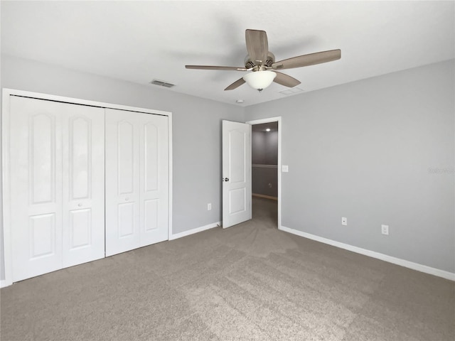 unfurnished bedroom with a closet, carpet flooring, visible vents, and baseboards