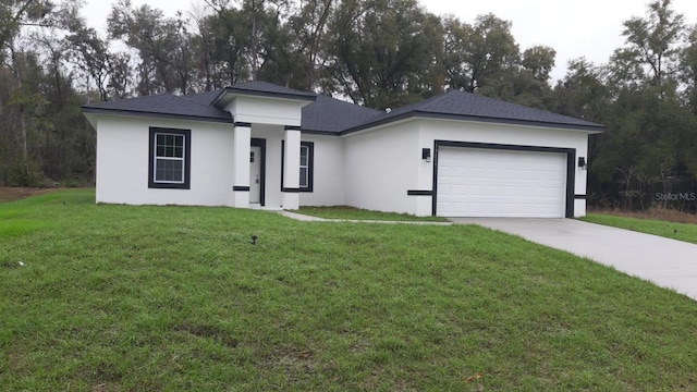 view of front of home with an attached garage, a front lawn, concrete driveway, and stucco siding