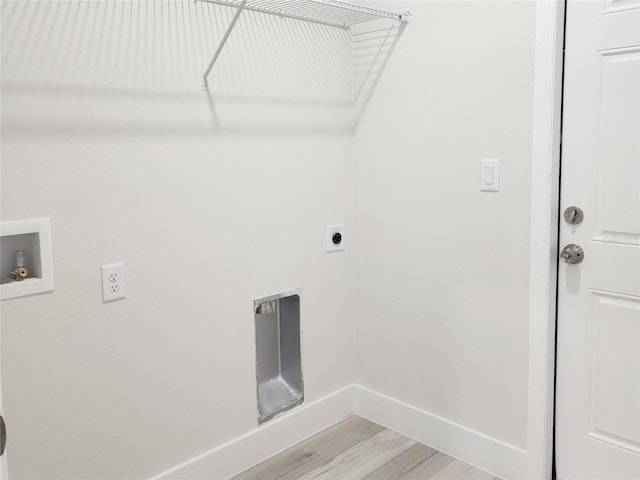 laundry area with hookup for a washing machine, light wood-style flooring, laundry area, baseboards, and electric dryer hookup