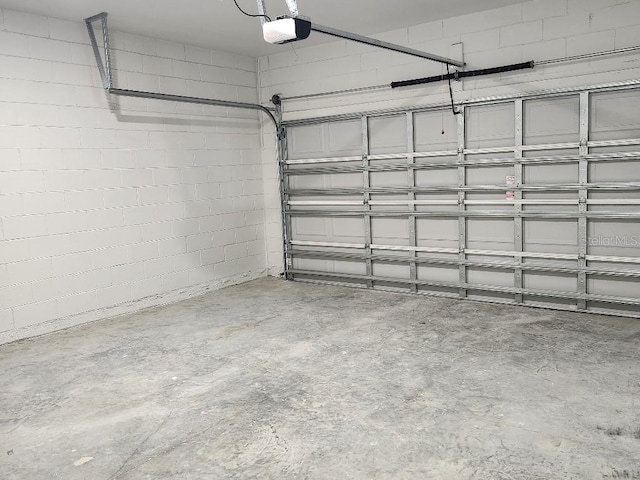 13215 SW 41st Ct, Ocala, FL 34473 - garage featuring concrete block wall and a garage door opener