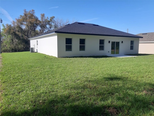 13215 SW 41st Ct, Ocala, FL 34473 - back of property featuring a lawn, stucco siding, and roof with shingles