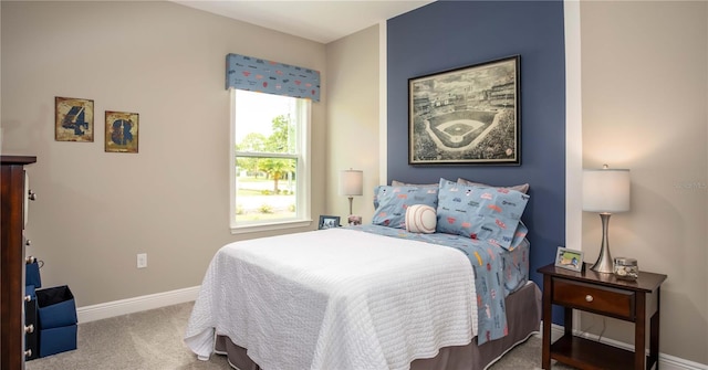 carpeted bedroom featuring baseboards