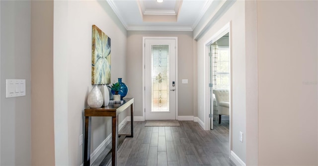 doorway to outside with ornamental molding, baseboards, and wood finished floors