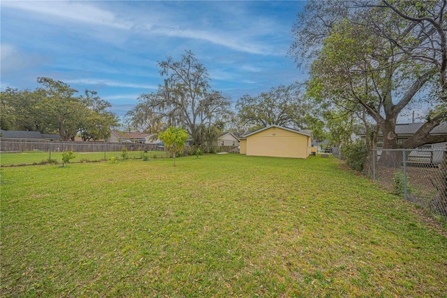 view of yard featuring a fenced backyard and an outdoor structure