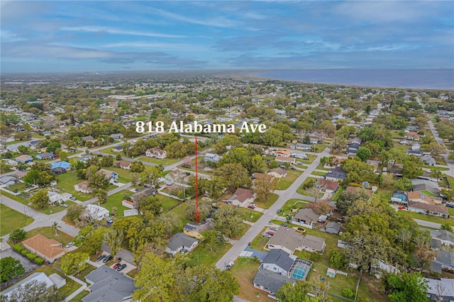 birds eye view of property with a residential view and a water view