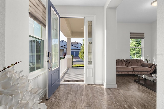 entryway with baseboards and wood finished floors