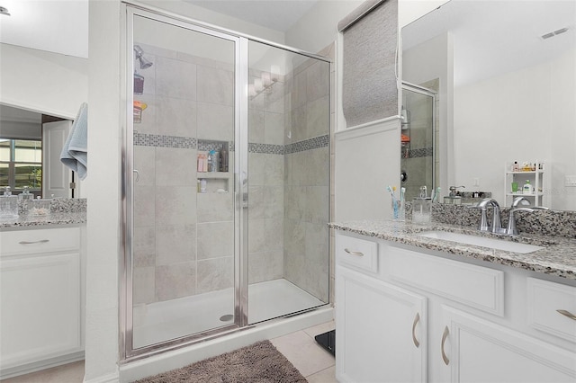 full bath featuring visible vents, a shower stall, vanity, and tile patterned floors