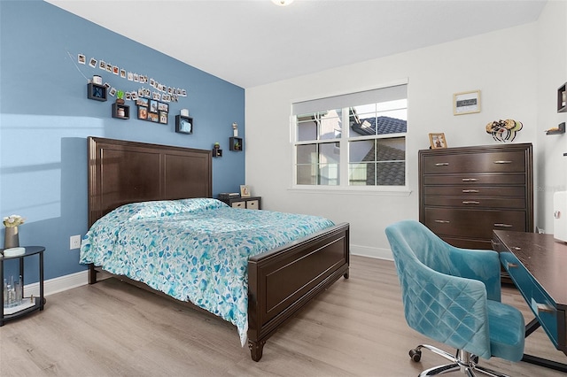 bedroom with baseboards and wood finished floors