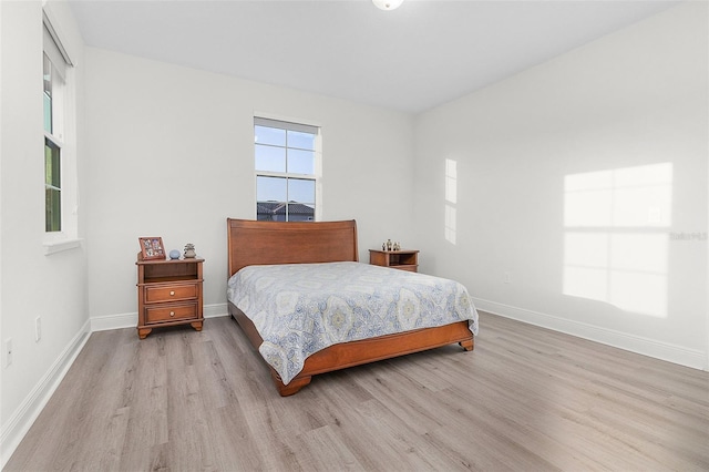 bedroom featuring baseboards and wood finished floors