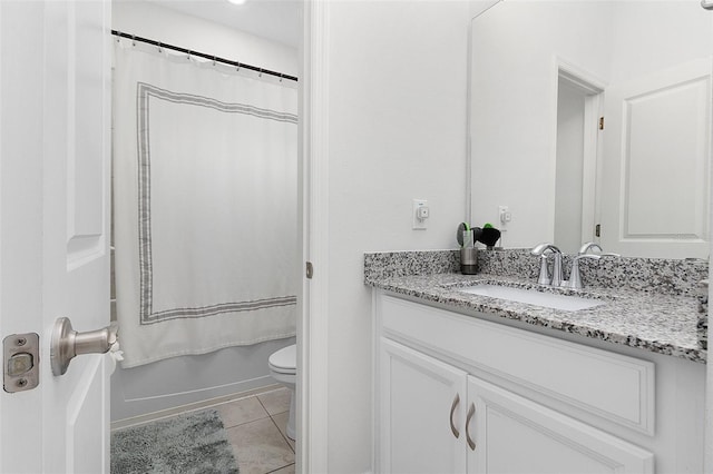 bathroom featuring tile patterned flooring, shower / bathtub combination with curtain, vanity, and toilet