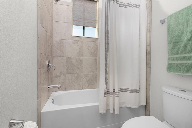 bathroom with shower / bath combo and toilet