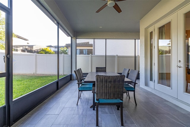 sunroom / solarium featuring ceiling fan