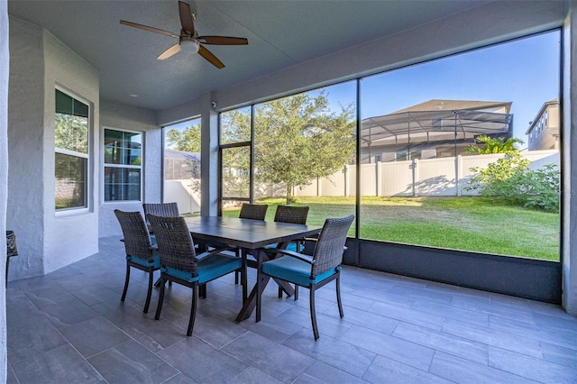 sunroom / solarium featuring a ceiling fan