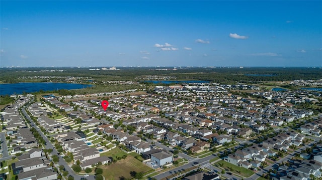 drone / aerial view with a water view and a residential view