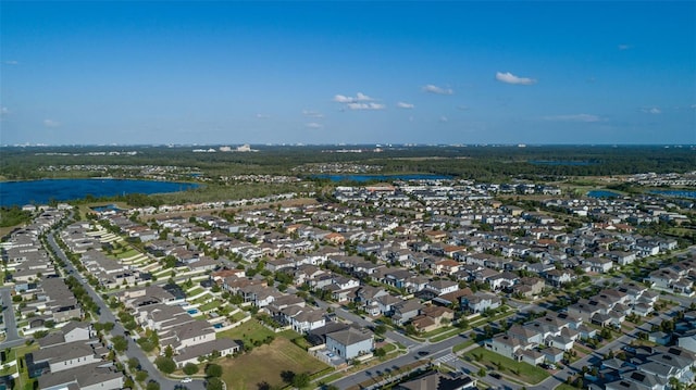 birds eye view of property with a residential view and a water view