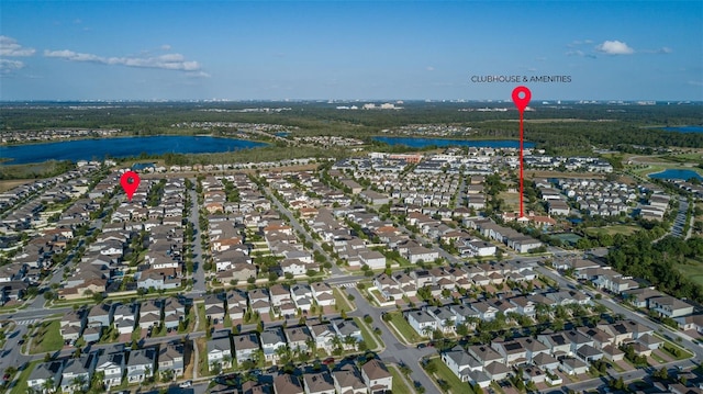 drone / aerial view featuring a water view and a residential view