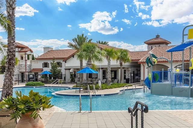 community pool featuring a patio area and fence