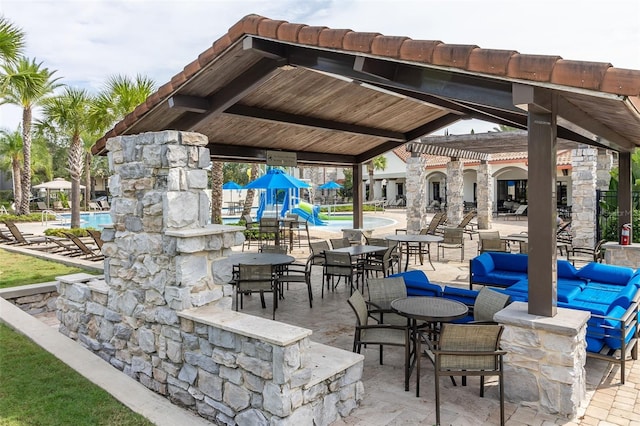 view of patio with a community pool and a pergola