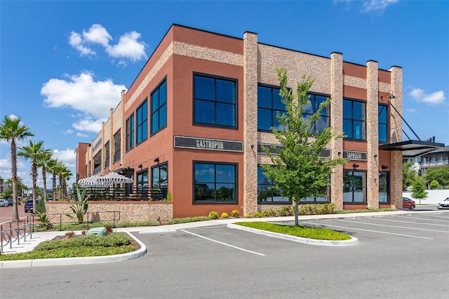 view of building exterior with uncovered parking