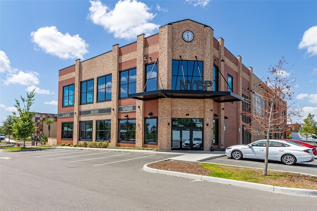 view of building exterior with uncovered parking