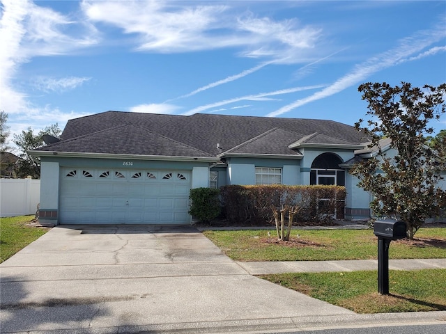 ranch-style home with a garage, concrete driveway, fence, and stucco siding