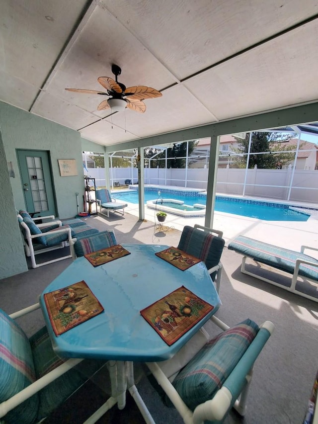 exterior space featuring glass enclosure, a patio area, a fenced backyard, and a fenced in pool