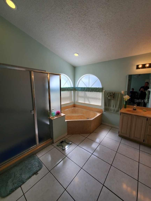 full bathroom with lofted ceiling, a textured ceiling, a bath, and tile patterned floors