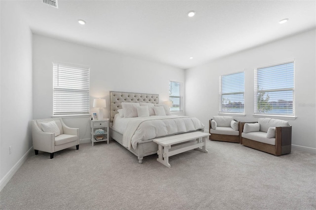 bedroom with multiple windows, recessed lighting, baseboards, and light carpet