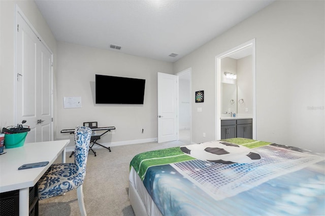 bedroom with visible vents, light carpet, baseboards, and ensuite bath