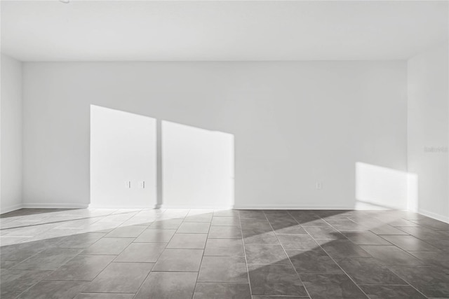 spare room featuring tile patterned flooring and visible vents