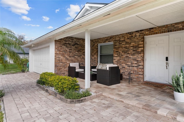 view of patio / terrace with a garage and outdoor lounge area