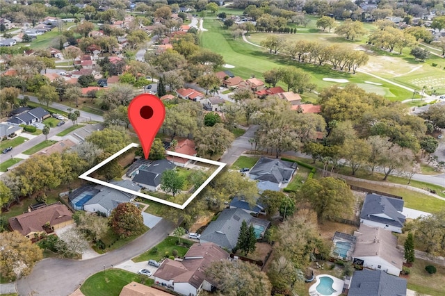 birds eye view of property with view of golf course and a residential view