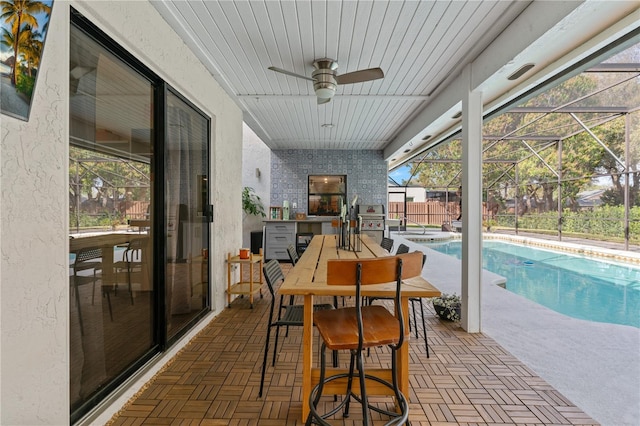 sunroom with wooden ceiling and ceiling fan