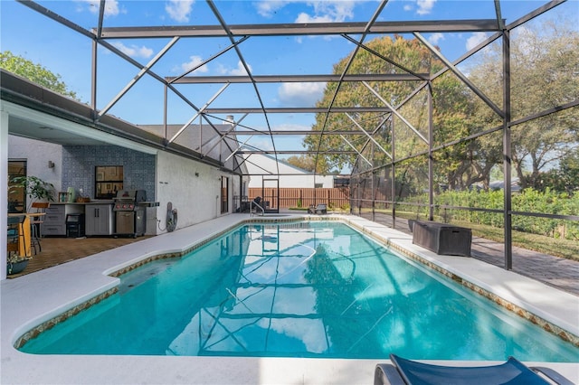 view of swimming pool with a patio, grilling area, and a lanai