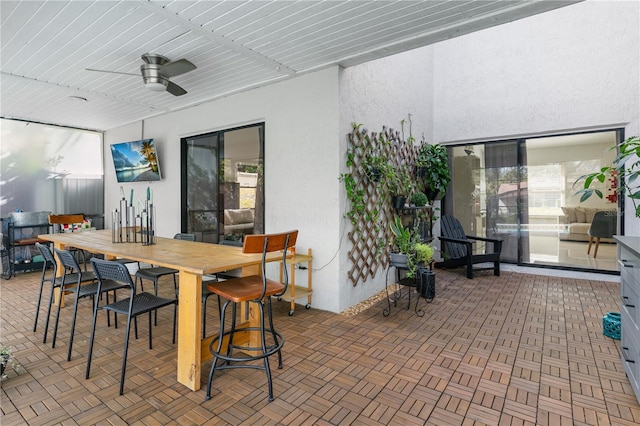 view of patio featuring ceiling fan and outdoor dining area